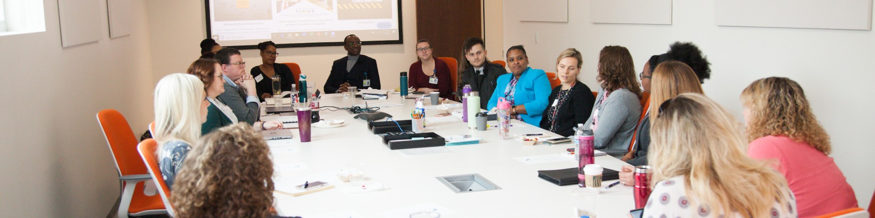 Diverse group of professionals collaborating at a large conference table.