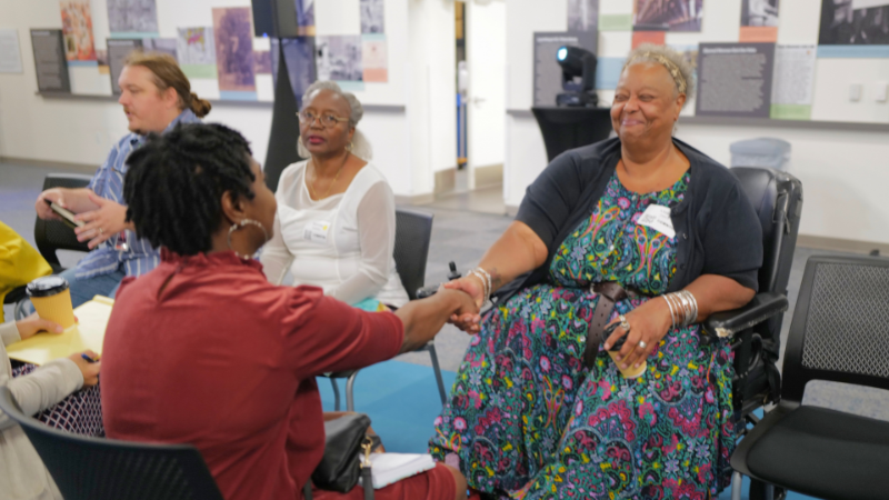 two women shaking hands and connecting