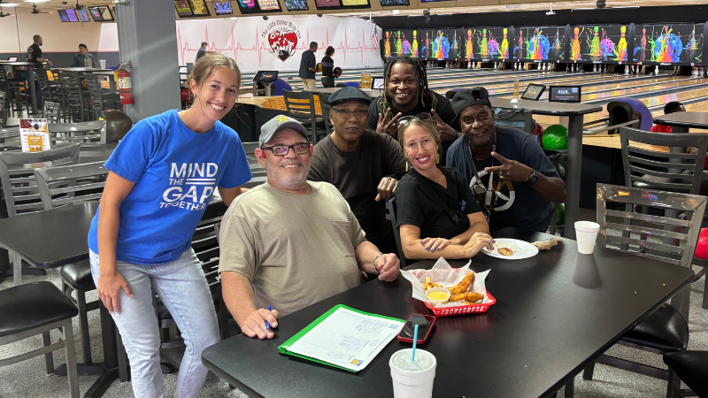 Staff and community members from Mind the Gap Together at a bowling alley