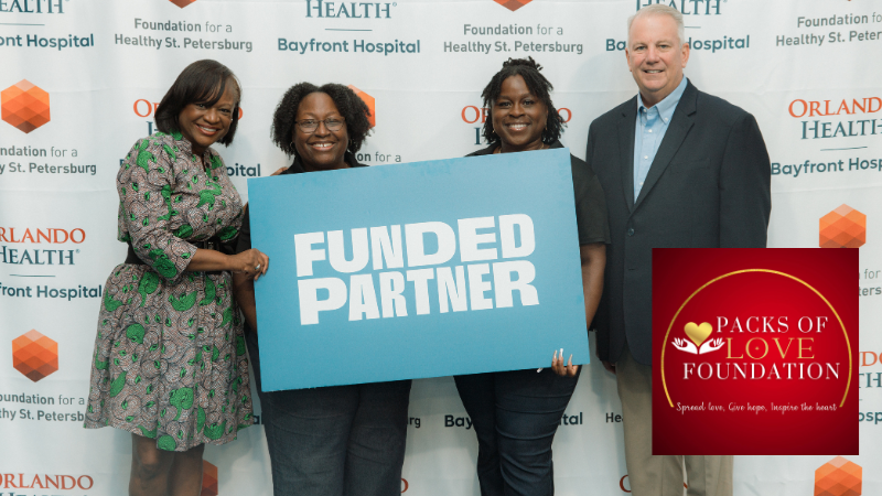 photo of Kanika Tomalin, two representatives from Packs of Love, and John Moore